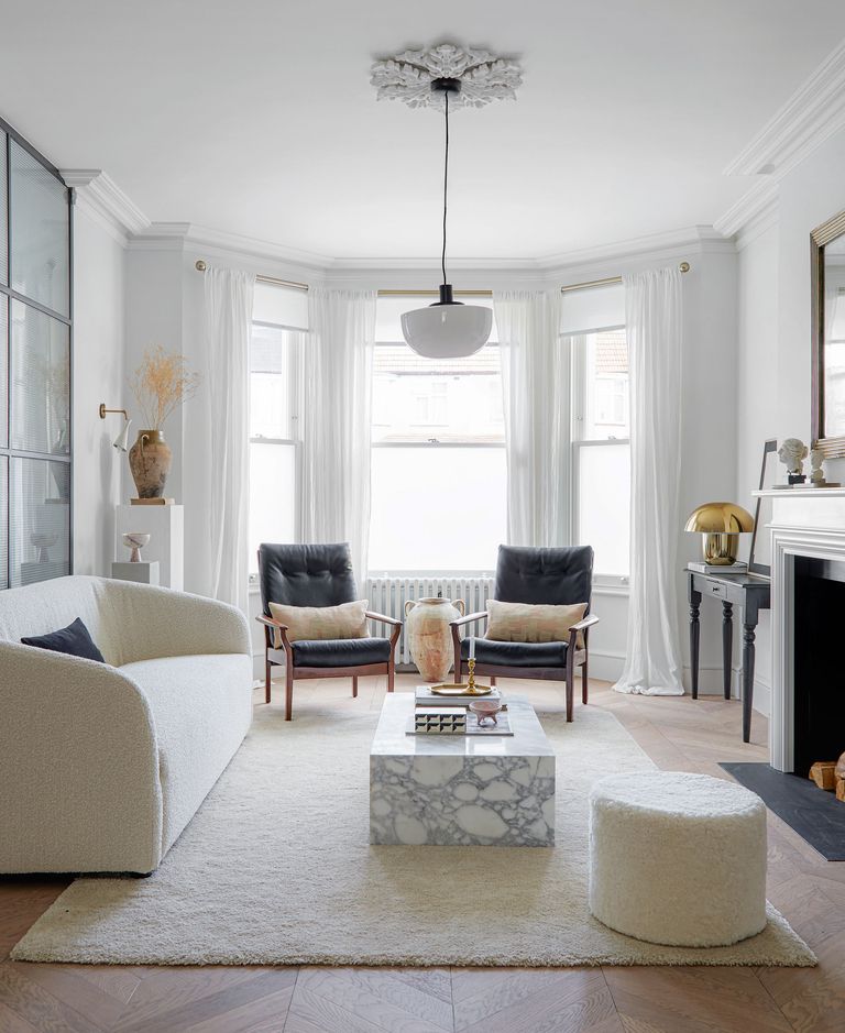 a contemporary living room with a marble coffee table