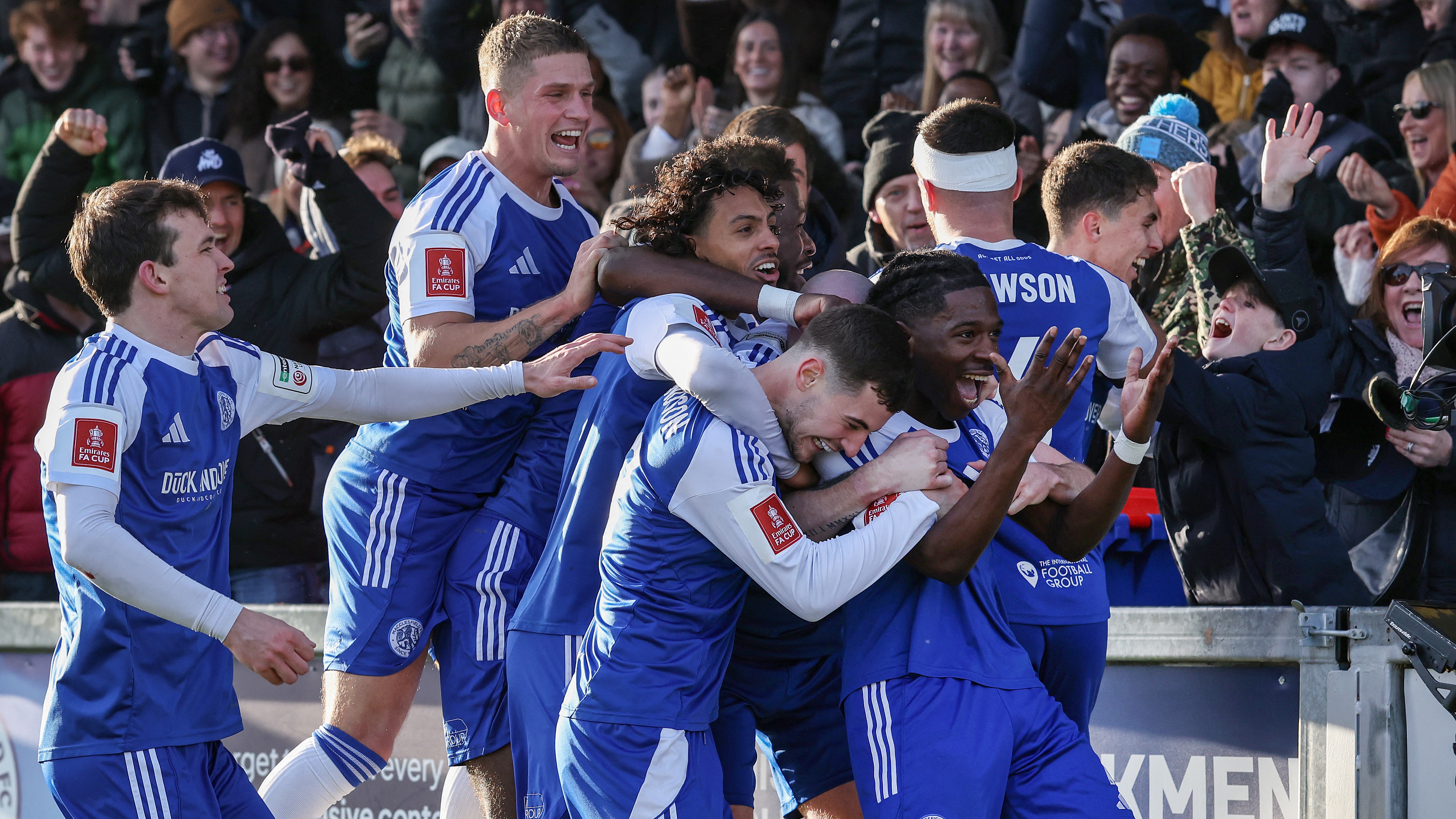 Macclesfield's English striker #07 Isaac Buckley-Ricketts (R) celebrates with teammates after scoring the team's second goal during the English FA Cup third round football match between Macclesfield Town and Crystal Palace at Leasing.com Stadium, Moss Rose in Macclesfield, northern England on January 10, 2026.
