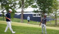 Min Woo Lee and Sahith Theegala search for a golf ball