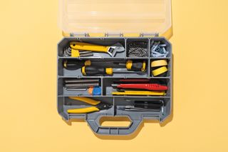 A stock image of a toolbox on a yellow background