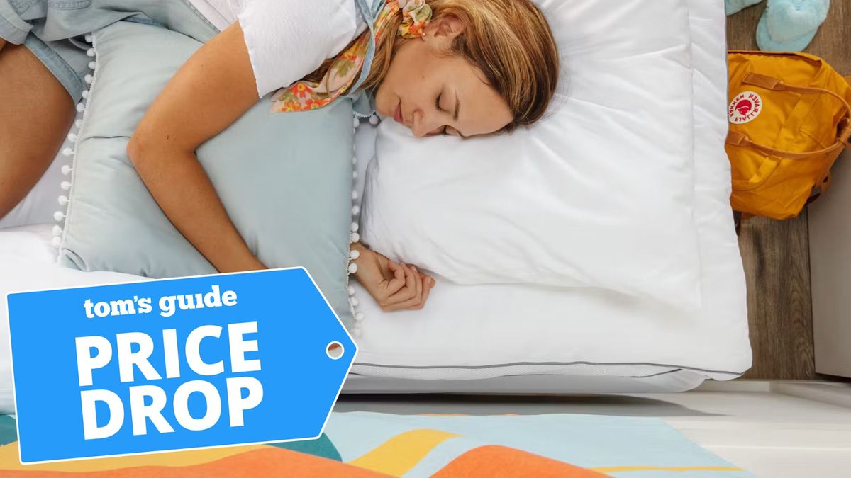 A young college student sleeps on the Viscosoft Hybrid Lux Mattress Topper with a sale label in the bottom left-hand corner