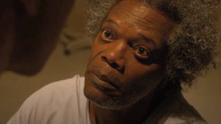 Samuel L Jackson looks up with a wild expression of confidence in Glass