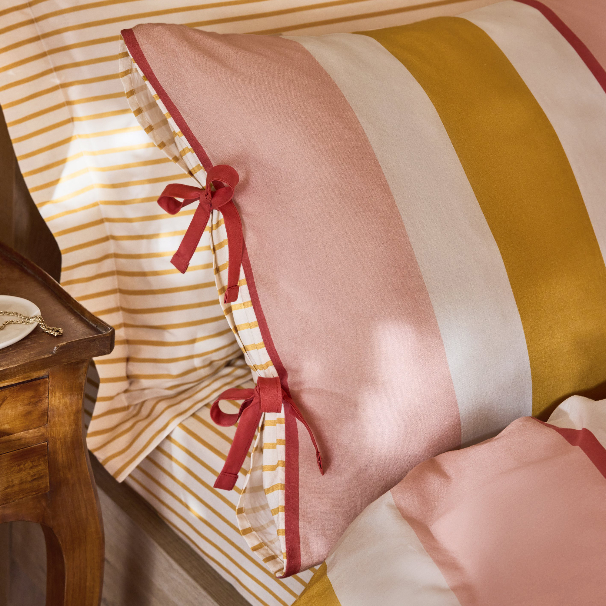 A detail of the red bows on the pillowcases of the FatFace bedding collection