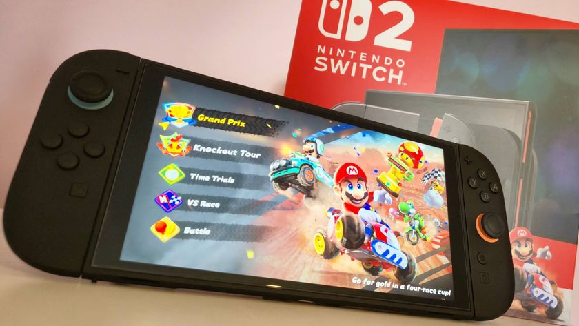 Photo of the Nintendo Switch 2 handheld running Mario Kart World sitting in front of a red Switch 2 box.