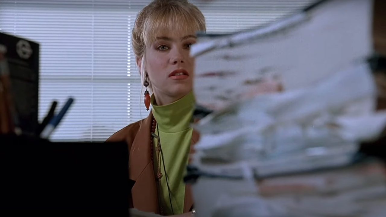 Christina Applegate looks intimidated by paperwork in Don't Tell Mom The Babysitter's Dead.
