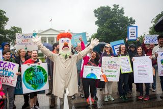 Members of the Union for Concerned Scientists pose for photographs with Muppet character Beaker in front of The White House before heading to the National Mall for the March for Science on April 22, 2017 in Washington, DC. The rally and march are being re