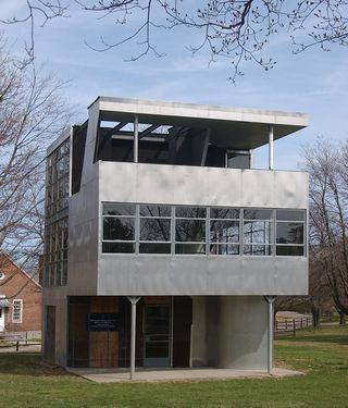 Three story metal framed house with terrace on top floor