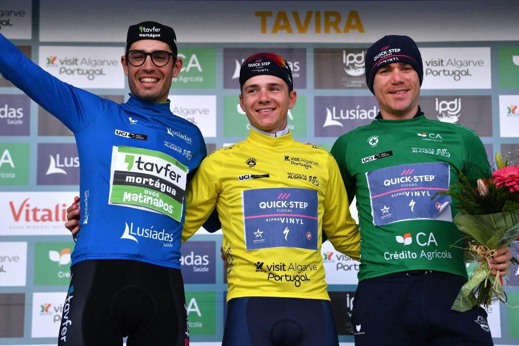 TAVIRA PORTUGAL FEBRUARY 19 LR Joo Carlos Arajo Matias of Portugal and Team TavferMortguaOvos Matinados Blue Mountain Jersey Remco Evenepoel of Belgium and Team QuickStep Alpha Vinyl Yellow Leader Jersey and Fabio Jakobsen of Netherlands and Team QuickStep Alpha Vinyl Green Points Jersey celebrate at podium during the 48th Volta Ao Algarve 2022 Stage 4 a 322km individual time trial from Vila Real de Santo Antnio to Tavira VAlgarve2022 on February 19 2022 in Tavira Portugal Photo by Luc ClaessenGetty Images