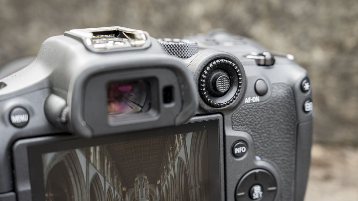 The Canon EOS R7 camera sitting on a stone step