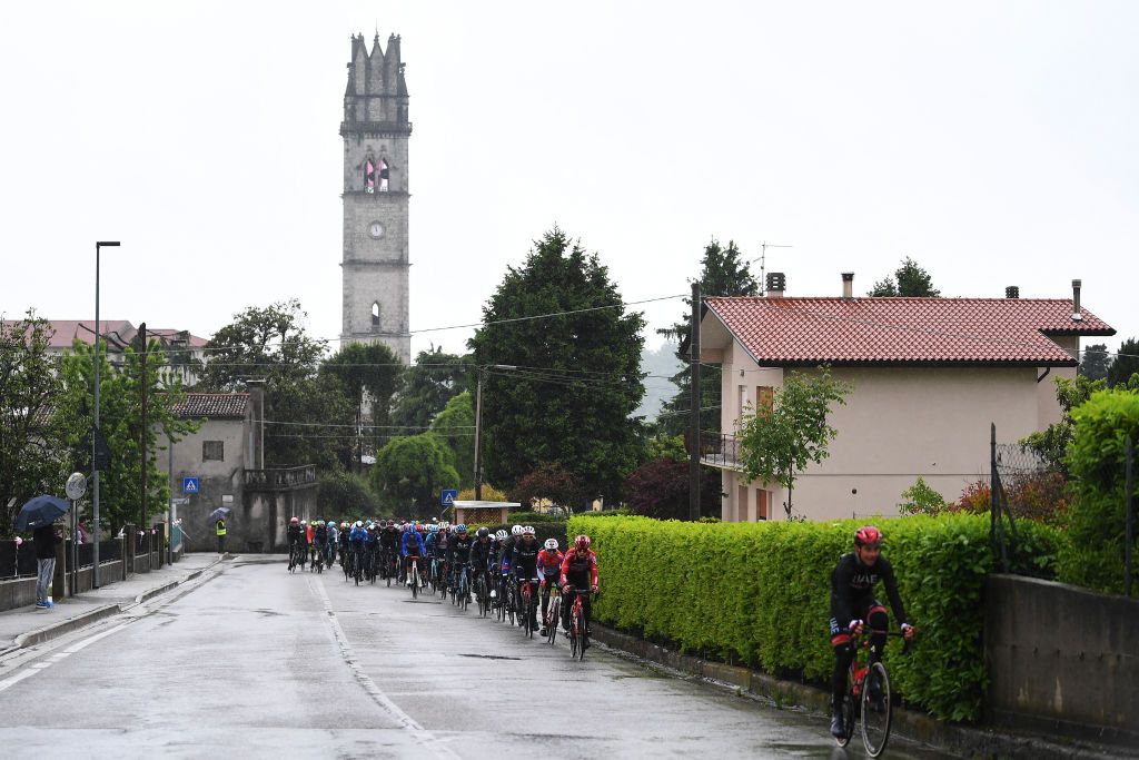 CORTINA DAMPEZZO ITALY MAY 24 The peloton passing through Fregona Village landscape during the 104th Giro dItalia 2021 Stage 16 a 153km stage shortened due to bad weather conditions from Sacile to Cortina dAmpezzo 1210m Rain girodiitalia Giro on May 24 2021 in Cortina dAmpezzo Italy Photo by Tim de WaeleGetty Images