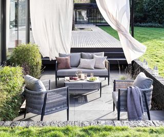 A sunken seating area in back garden with luxurious seating