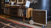 A modern living room with a turntable, speakers and subwoofer