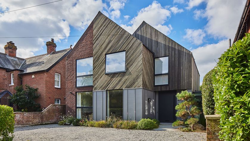 View of a self build with a gravel driveway. It is a detached home with double pitched roof