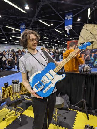 GW.com EIC Michael Astley-Brown holds one of Jack White's touring guitars at the 2024 NAMM show