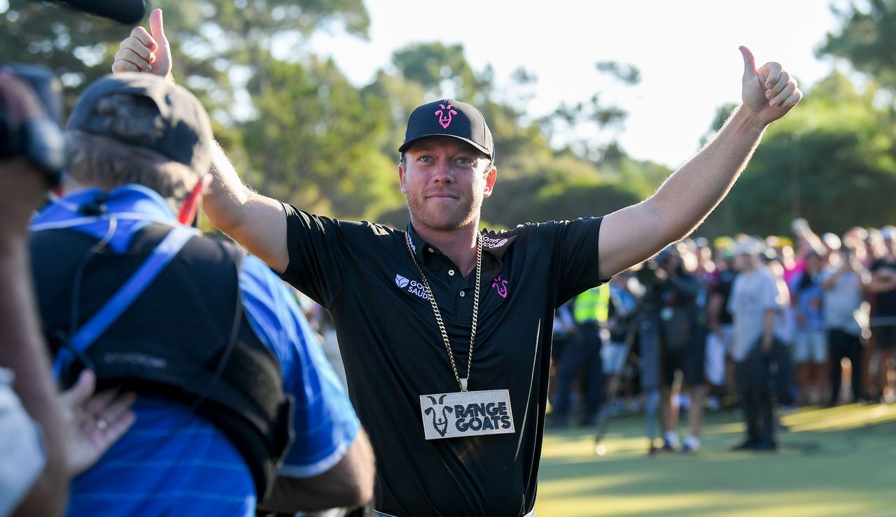 Gooch sticks his thumbs up to the crowd as he gets his picture taken