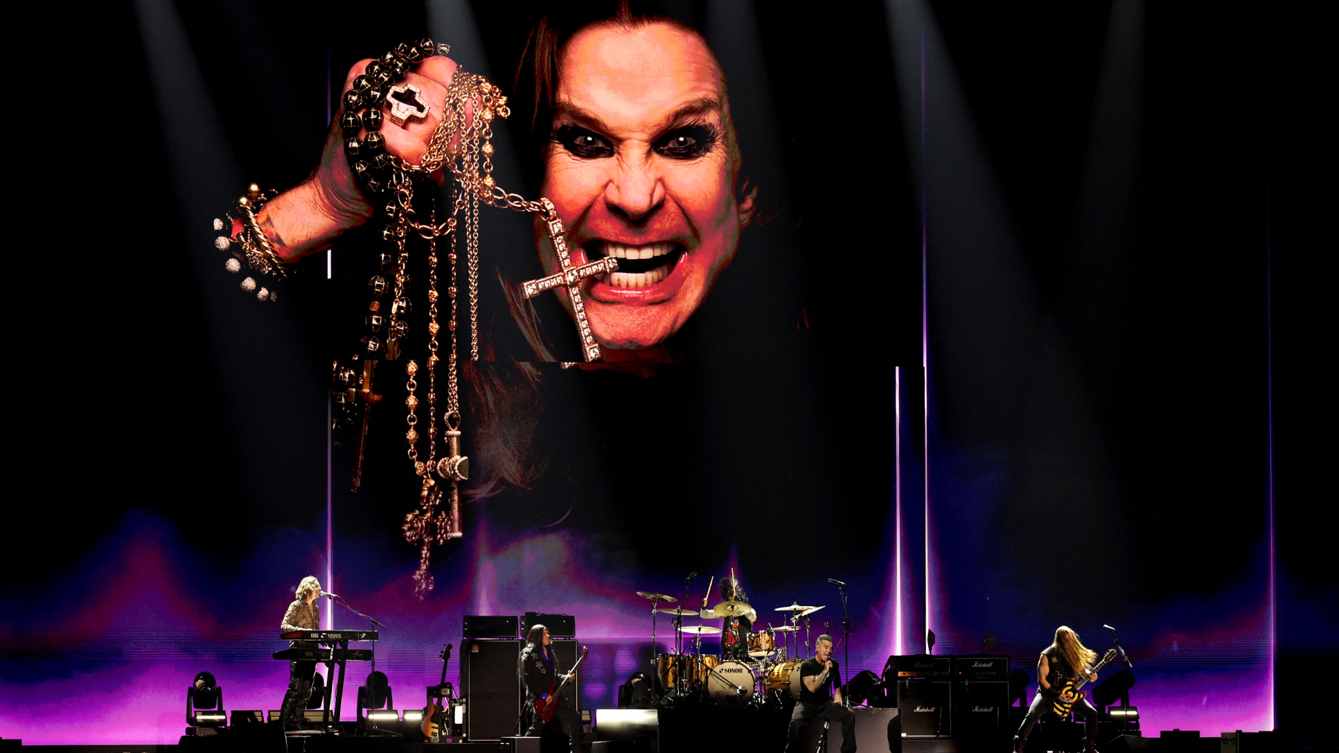 British singer Robbie Williams performs during a tribute to late English singer Ozzy Osbourne (pictured at top) during the BRIT Awards 2026