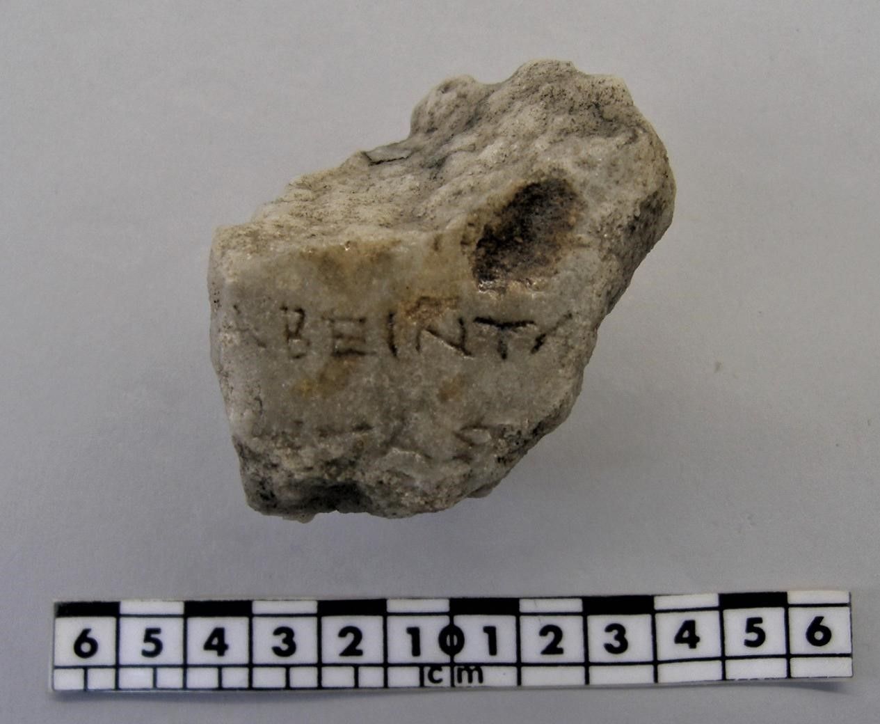 A fragment of a column with part of an inscription.