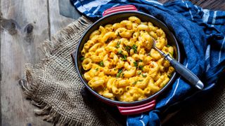 Macaroni cheese in a cast iron dish on a tablecloth