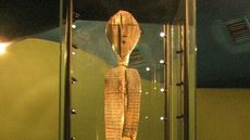 A tall carved statue in a museum