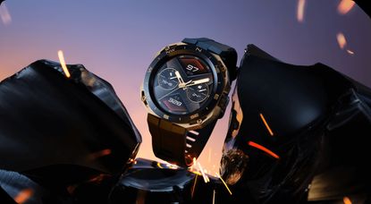 The Huawei Watch GT Cyber in front of a sunset