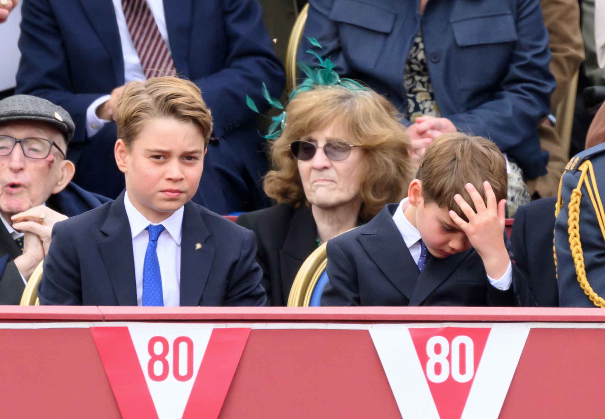 Prince George and Prince Louis sitting next to each other at the VE Day parade