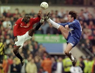 Manchester United's Andy Cole and Chelsea's Craig Burley challenge for a ball in the FA Cup semi-finals in March 1996.