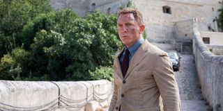 James Bond (Daniel Craig) stands on a stone bridge in 'No Time To Die'