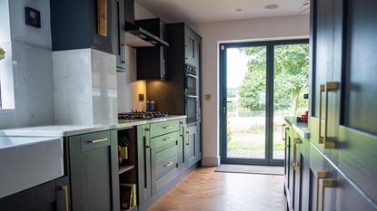 kitchen with blue cabinetry and bi-fold doors