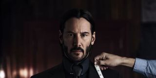 Keanu reeves as John Wick being fitted for a suit