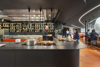 interior of the mutti canteen by carli ratti in parma, the staff canteen and restaurant of the tinned tomato company showing orange floors and glazed facades