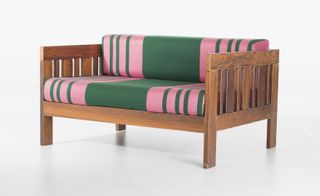 Wooden sofa with pink and green stiped cushions
