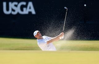 Scottie Scheffler plays from a bunker