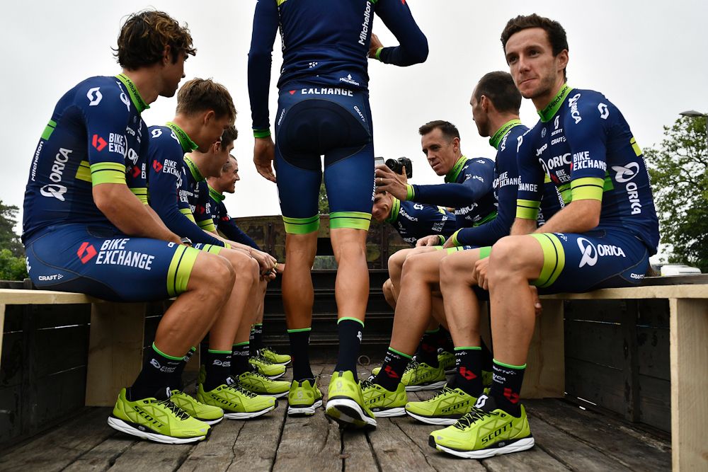 Riders of the Australia's Orica Greenedge cycling team take part in a parade aboard an World War II US army vehicle during the team presentation ceremony in Sainte-Mere-Eglise