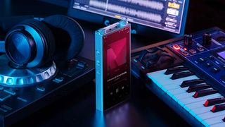 The A&K PD20 next to a keyboard and headphones.