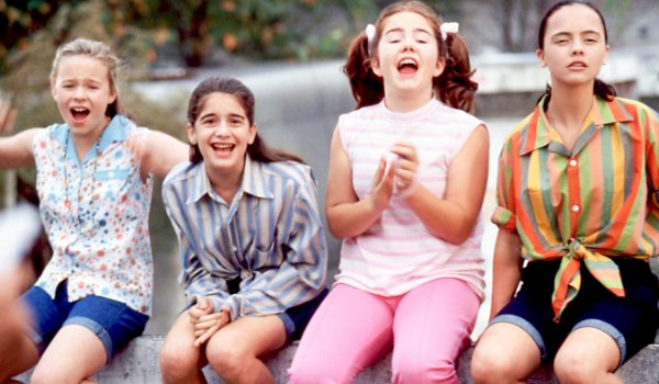 Now And Then the girls sit on the bridge, reacting to something off camera