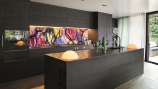 abstract coloured glass splashback in black kitchen