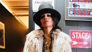 Linda Perry standing backstage