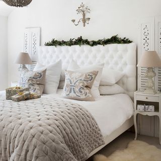 bedroom with white wall pillow and table lamp