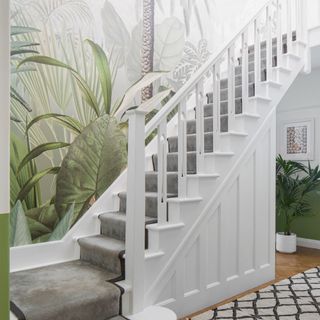 Botanical wall mural on a white staircase with grey runner