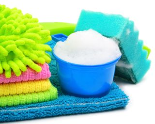 microfiber cloths, sponge and plastic container with suds