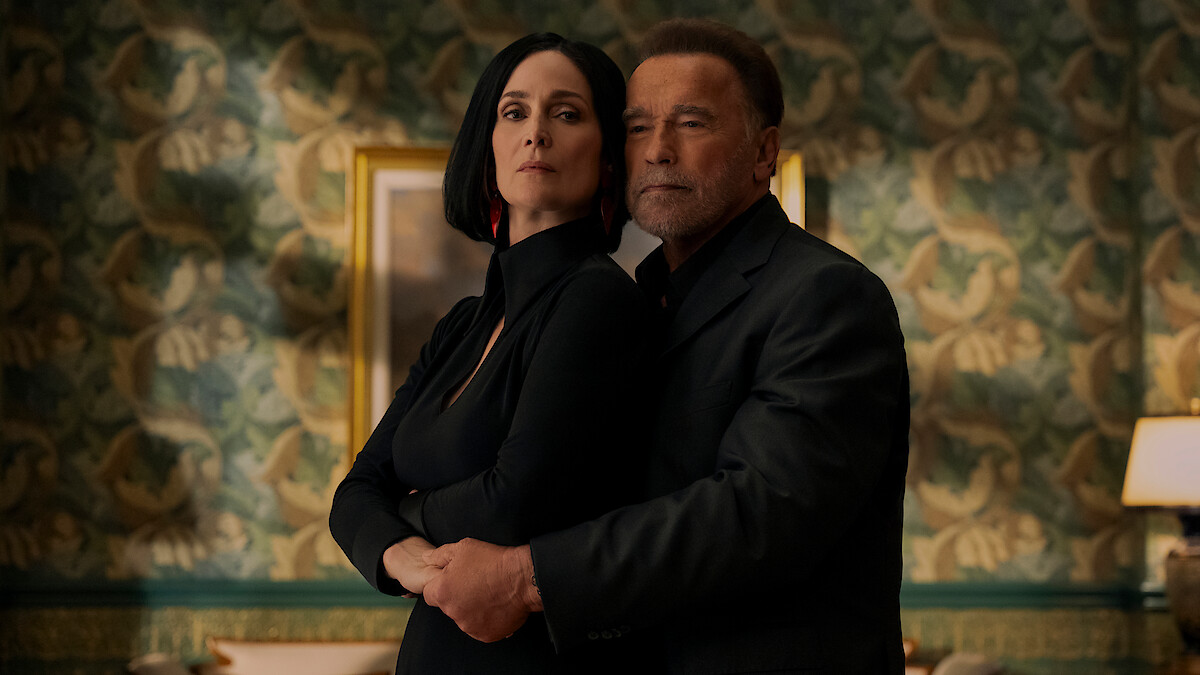 Luke and Greta standing in a room close to each other in Fubar season 2 on Netflix