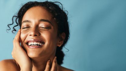 woman smiling with blue background