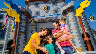 Legoland California Castle Hotel exterior with smiling family