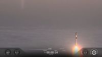 A SpaceX rocket rises out of the clouds and fog during a classified launch to space.