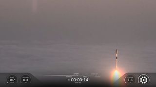 A SpaceX rocket rises out of the clouds and fog during a classified launch to space.