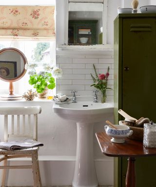 traditional bathroom with white sanitaryware and white metro tiles and vintage green metal locker