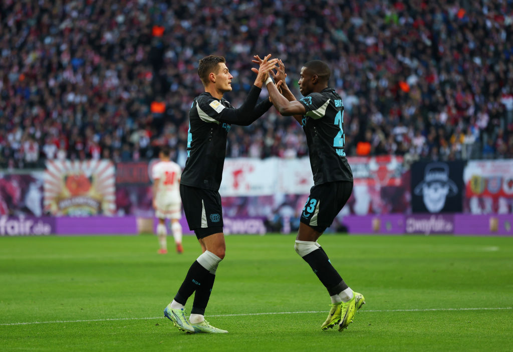 Patrik Schick of Bayer 04 Leverkusen celebrates scoring his team's first goal with teammate Nordi Mukiele during the Bundesliga match between RB Leipzig and Bayer 04 Leverkusen at Red Bull Arena on January 25, 2025 in Leipzig, Germany.