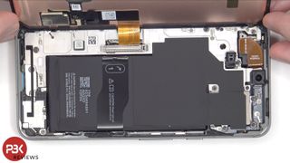 A screenshot of a Google Pixel 8 teardown video, showing the phone's main body under the display