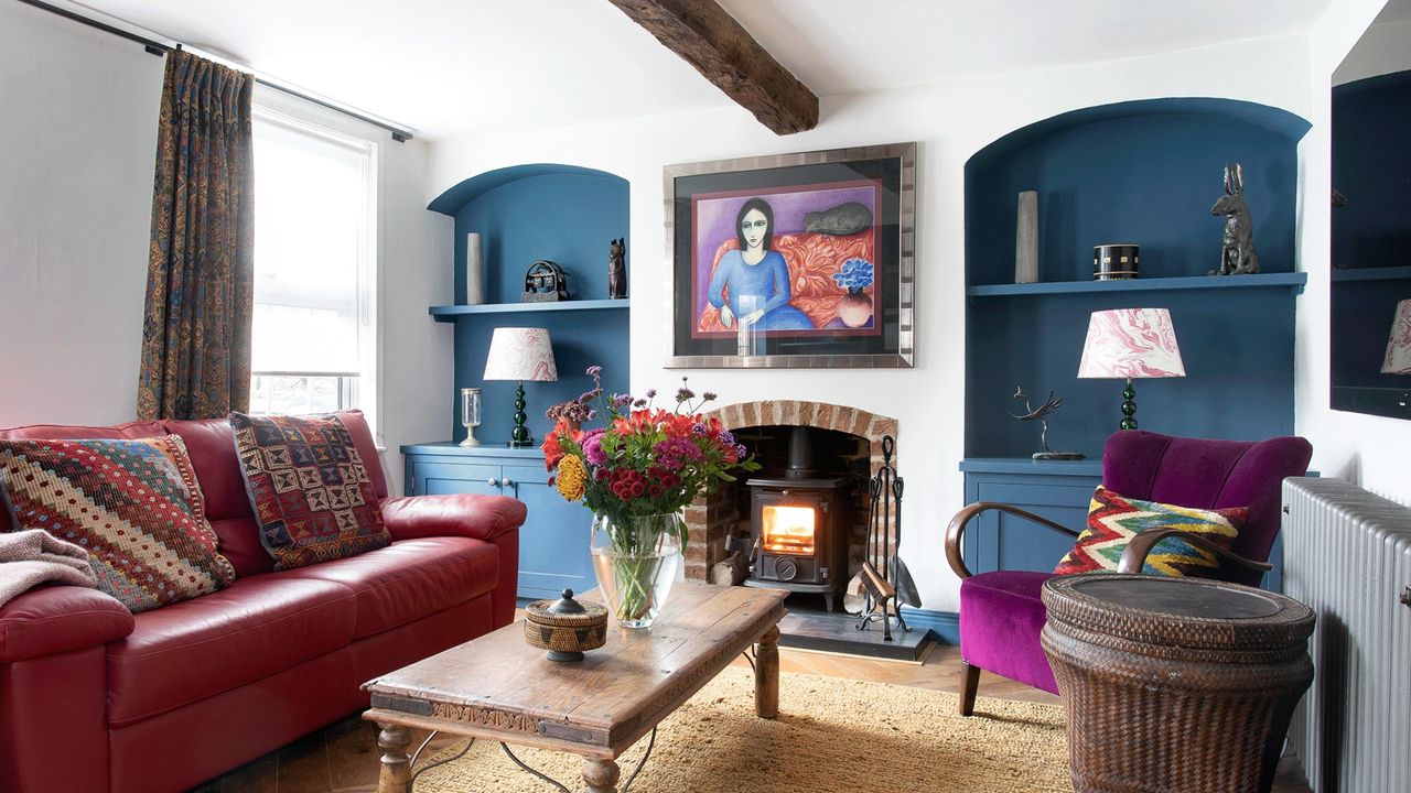 living room with red sofa and fireplace 