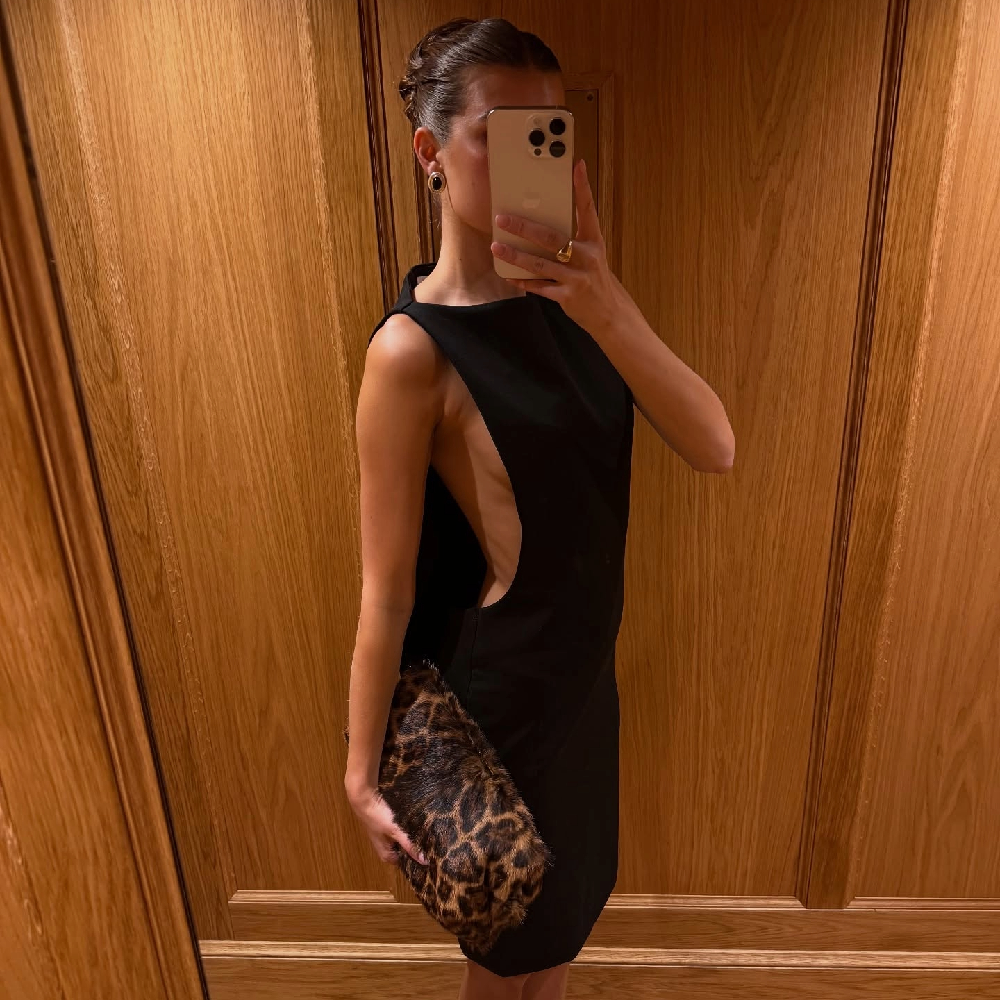 Sara Walker in a black dress and leopard Saint Laurent bag